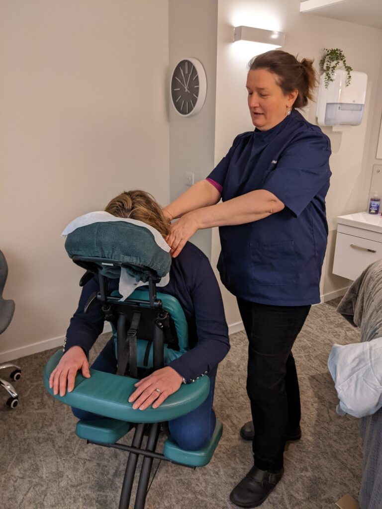 Lilian MacMillan massage therapist giving a chair massage.